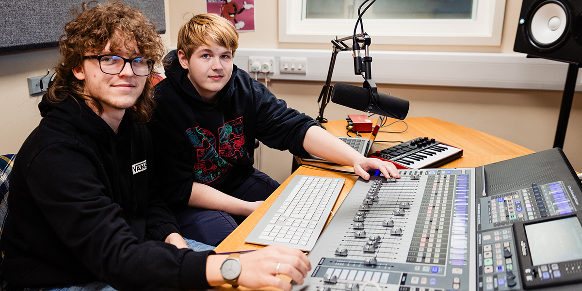 Music students using recording studio equipment